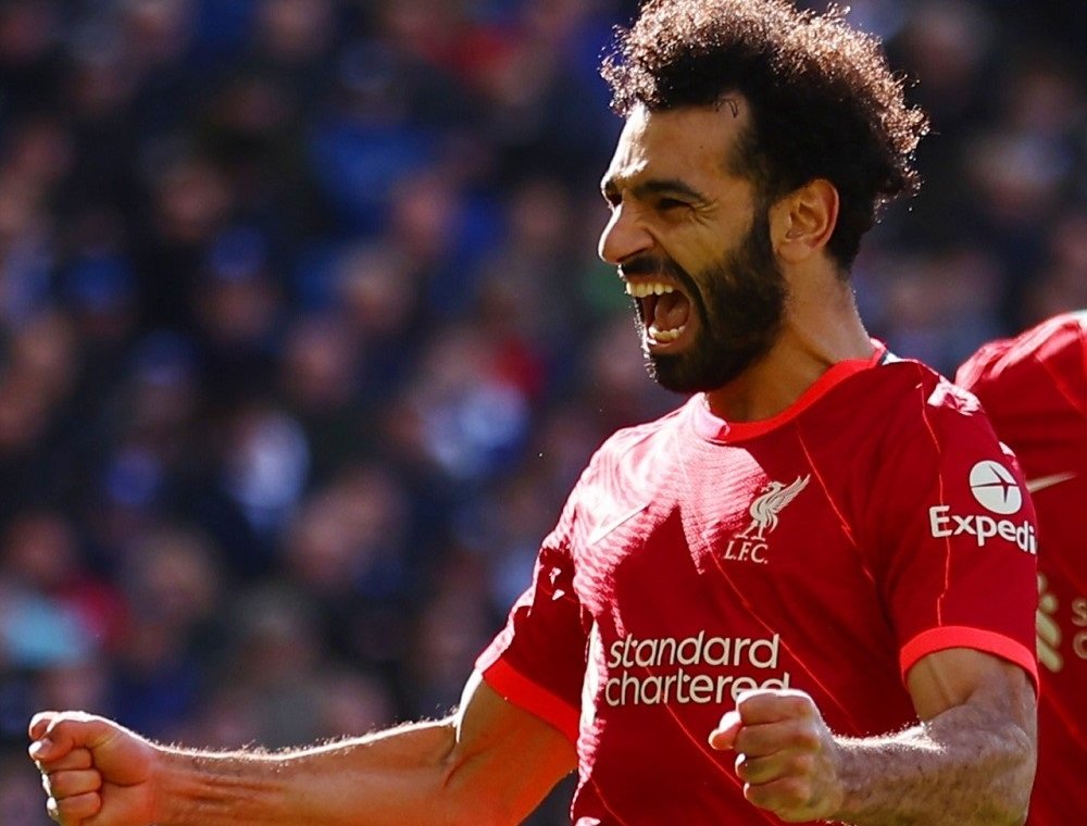 Com o uniforme vermelho do Liverpool, Salah comemora o gol estendendo os braços