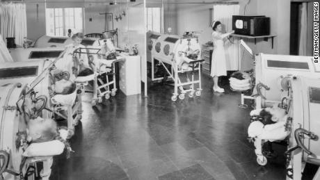 Iron lung patients at a Baltimore hospital get TVs for the first time. Mirrors allow them to watch broadcasts.