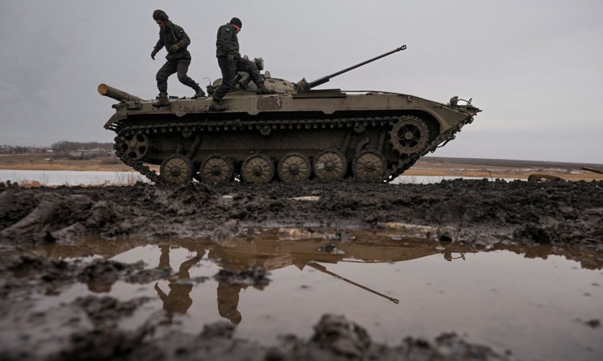 Ukrainian service members walk on an armored fighting vehicle during a training exercise in eastern Ukraine