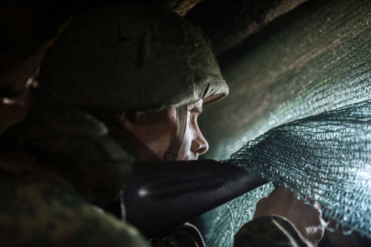 Pro-Russian separatists observe the movement of Ukrainian troops from trenches in Ukraine