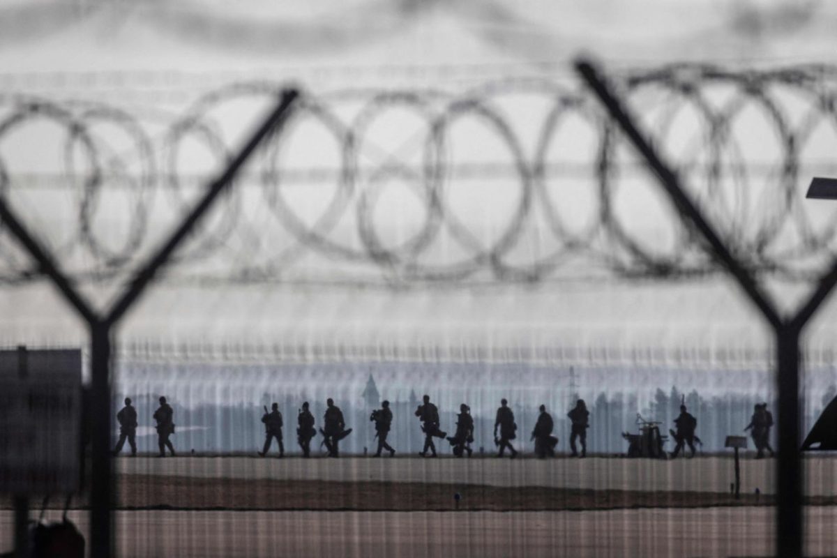 US troops walk on the tarmac at the Rzeszów-Jasionka Airport in southeastern Poland on February 16. US paratroopers landed in Poland as part of a deployment of several thousand sent to bolster NATO
