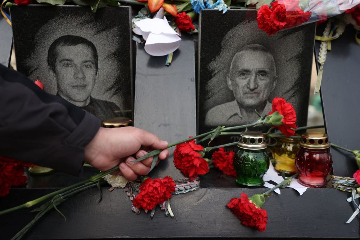 People lay flowers at the Motherland Monument in Kyiv on February 21.