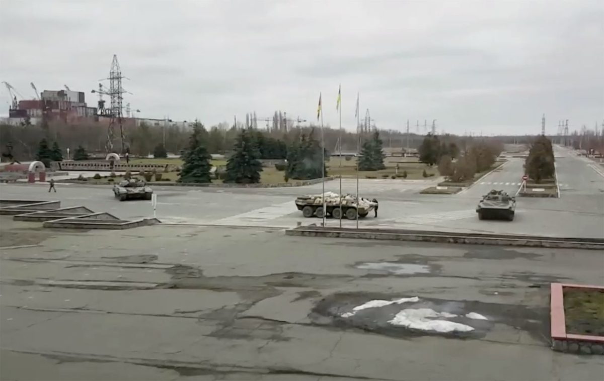 Russian military vehicles are seen at the Chernobyl power plant near Pripyat, Ukraine, on February 24. Russian forces <a href=