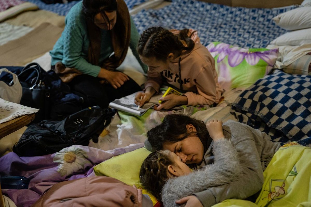 A woman named Helen comforts her 8-year-old daughter, Polina, in the bomb shelter of a Kyiv children