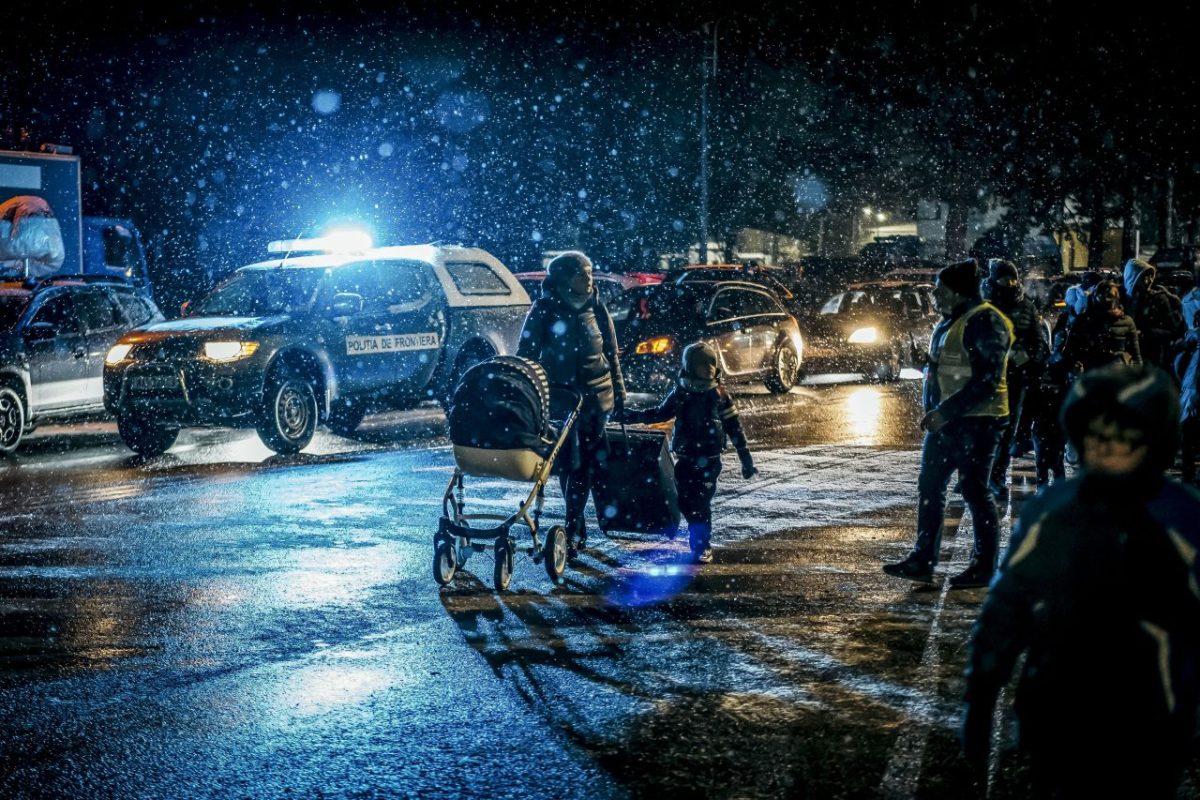 A Ukrainian woman takes her children over the border in Siret, Romania, on March 2. Many Ukrainians are fleeing the country at a pace that could turn into 