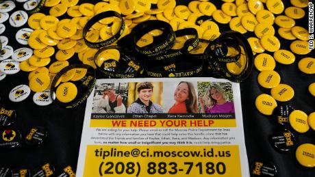 A flyer seeking information about the killings of four University of Idaho students who were found dead on Nov. 13, 2022, is displayed on a table along with buttons and bracelets, Wednesday, Nov. 30 during a vigil in memory of the victims in Moscow, Idaho. 
