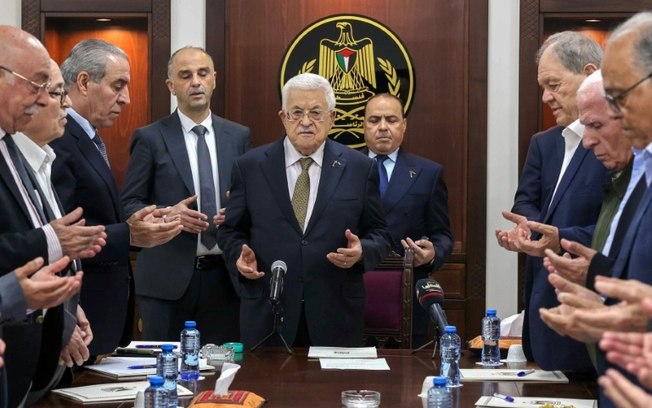 Foto divulgada pela Autoridade Palestina mostra o presidente Mahmoud Abbas (centro) conduzindo orações próximo a Hussein al Sheikh (3º à esquerda) durante encontro do Comitê Executivo da organização em Ramallah
