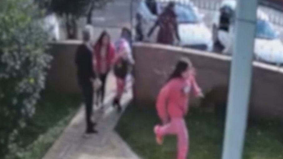 Moradora abre portão e abriga crianças que corriam na rua, nas proximidades da escola Moradora abre portão e abriga crianças que corriam na rua, nas proximidades da escola